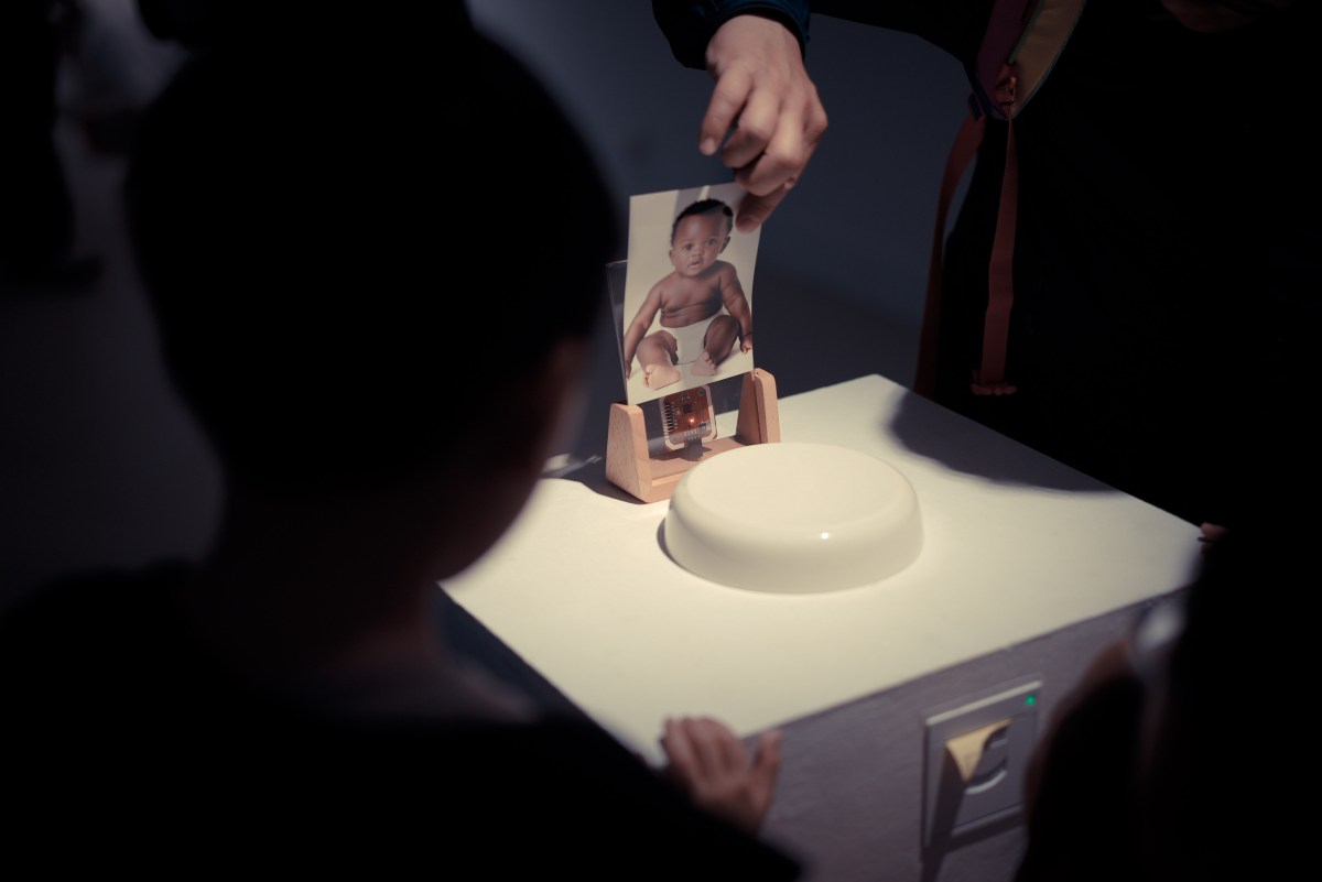 Visitor selecting a baby photograph for the installation